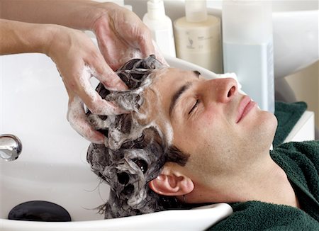 Young man having his hair  washed at a salon Stock Photo - Premium Royalty-Free, Code: 644-01435809