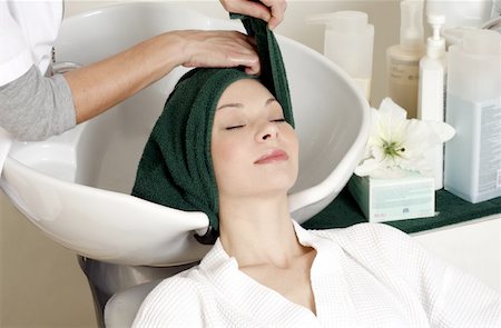 Young woman  having her hair washed at a salon Stock Photo - Premium Royalty-Free, Code: 644-01435823