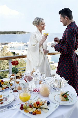 Mature couple having breakfast on hotel terrace Stock Photo - Premium Royalty-Free, Code: 644-01436097