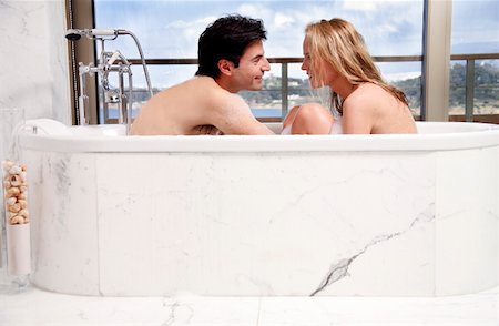 Couple enjoying bubble bath together Stock Photo - Premium Royalty-Free, Code: 644-01436121