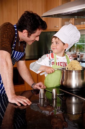 Father and son cooking spaghetti Stock Photo - Premium Royalty-Free, Code: 644-01436262