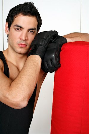 student fighting - Young man leaning on punching bag Stock Photo - Premium Royalty-Free, Code: 644-01436520