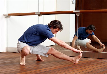 simsearch:644-01436949,k - Young man stretching in gym Stock Photo - Premium Royalty-Free, Code: 644-01436538