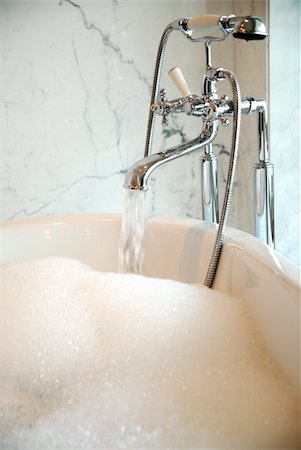 front of expensive house - Water running into bubble bath Stock Photo - Premium Royalty-Free, Code: 644-01436592