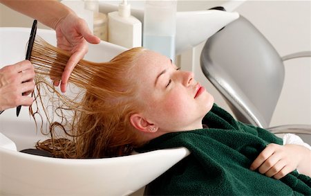 Young woman  having her hair washed at a salon Stock Photo - Premium Royalty-Free, Code: 644-01437000