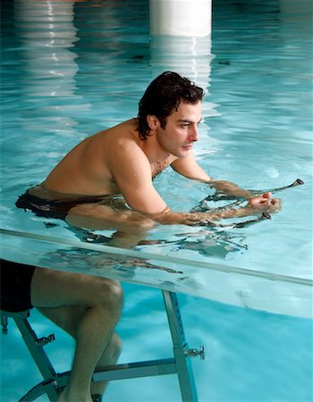 simsearch:644-01437057,k - Young man on exercise bike in spa pool Stock Photo - Premium Royalty-Free, Code: 644-01437080