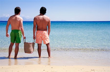 simsearch:400-07553490,k - Two men on the beach looking out to sea Stock Photo - Premium Royalty-Free, Code: 644-01437786