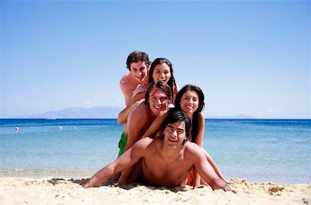 pyramid island - Group of friends piling into a pyramid Stock Photo - Premium Royalty-Free, Code: 644-01437789