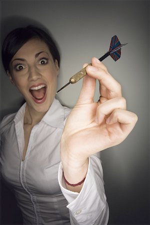 Office worker holding a dart Stock Photo - Premium Royalty-Free, Code: 644-01630888