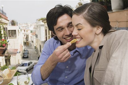 Man feeding woman at restaurant Stock Photo - Premium Royalty-Free, Code: 644-01631319