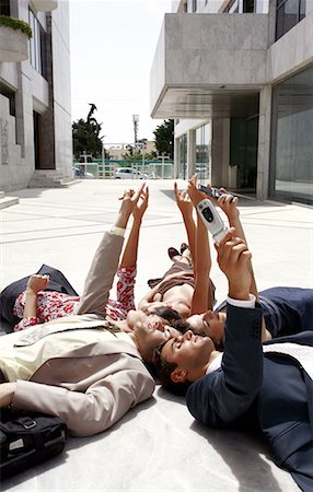 person protest - Business people lying on the ground pointing Stock Photo - Premium Royalty-Free, Code: 644-01631492