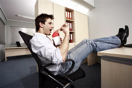 Office worker eating Chinese food at desk Stock Photo - Premium Royalty-Free, Code: 644-01825278