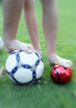 Two children's legs with balls Stock Photo - Premium Royalty-Free, Code: 644-02060437