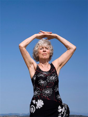 Female senior stretching on beach Stock Photo - Premium Royalty-Free, Code: 644-02060685