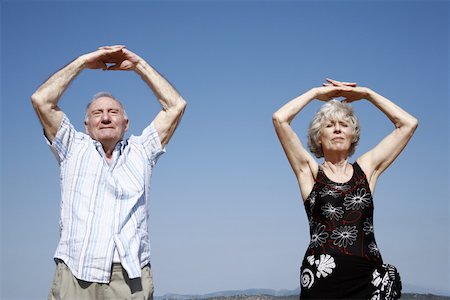 Senior couple stretching on beach Stock Photo - Premium Royalty-Free, Code: 644-02060686