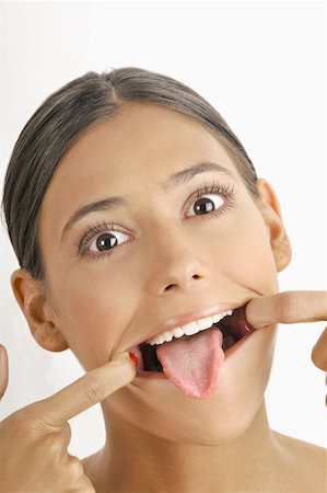 simsearch:644-02153088,k - Female young adult face; stretching mouth open;tongue out Stock Photo - Premium Royalty-Free, Code: 644-02152707