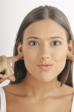 simsearch:644-02152735,k - Female young adult;plugging ears with fingers Stock Photo - Premium Royalty-Free, Code: 644-02152714