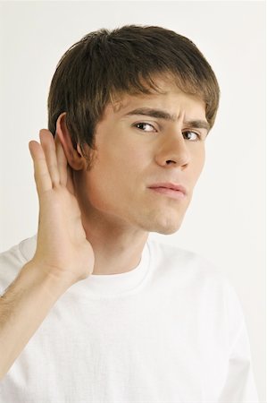 straining (overexertion) - Young male adult;straining to hear Stock Photo - Premium Royalty-Free, Code: 644-02152825