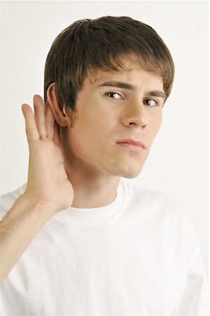 straining (overexertion) - Young male adult;straining to hear Stock Photo - Premium Royalty-Free, Code: 644-02152823