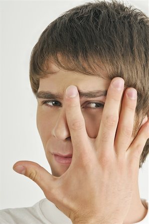 simsearch:644-02152735,k - Young male adult;looking through fingers Stock Photo - Premium Royalty-Free, Code: 644-02152834