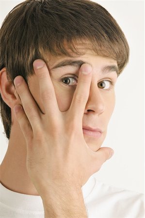 simsearch:644-02152735,k - Young male adult;looking through fingers Stock Photo - Premium Royalty-Free, Code: 644-02152836