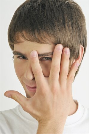 simsearch:644-02152735,k - Young male adult;looking through fingers Stock Photo - Premium Royalty-Free, Code: 644-02152833