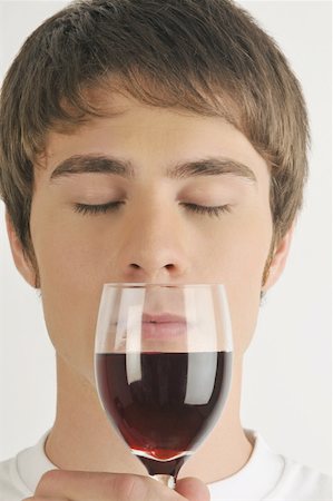 simsearch:644-02153088,k - Young male adult smelling a glass of red wine Stock Photo - Premium Royalty-Free, Code: 644-02152845
