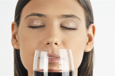 simsearch:644-02153088,k - Female young adult smelling a glass of red wine Stock Photo - Premium Royalty-Free, Code: 644-02152880
