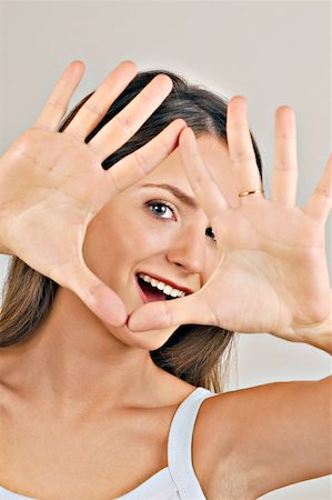 simsearch:644-02152735,k - Female young adult looking through hands Stock Photo - Premium Royalty-Free, Code: 644-02152950