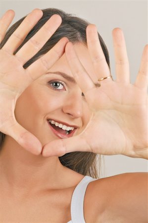 simsearch:644-02152735,k - Female young adult looking through hands Stock Photo - Premium Royalty-Free, Code: 644-02152951