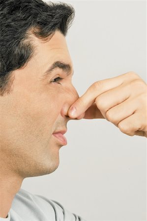 Young male adult holding nose Stock Photo - Premium Royalty-Free, Code: 644-02152978