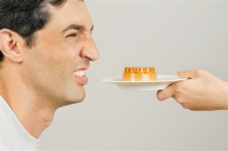 simsearch:644-02153088,k - Young male adult being offered a dessert Stock Photo - Premium Royalty-Free, Code: 644-02152984