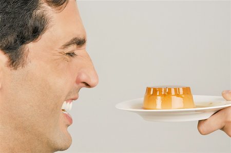 simsearch:644-02153088,k - Young male adult being offered a dessert Stock Photo - Premium Royalty-Free, Code: 644-02152981