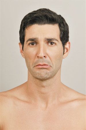 Young male adult face;upset expression Stock Photo - Premium Royalty-Free, Code: 644-02153025