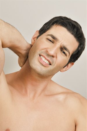 Young male adult;holding neck in pain Stock Photo - Premium Royalty-Free, Code: 644-02153035