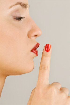 simsearch:644-02153088,k - Female young adult;finger to lips Stock Photo - Premium Royalty-Free, Code: 644-02153060