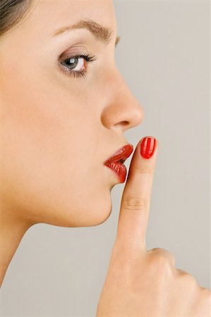 Female young adult;finger to lips Stock Photo - Premium Royalty-Free, Code: 644-02153063