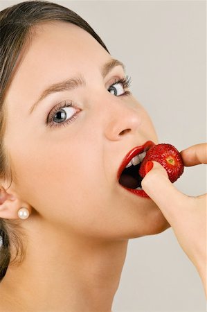 simsearch:644-02152735,k - Female young adult eating a strawberry Stock Photo - Premium Royalty-Free, Code: 644-02153071