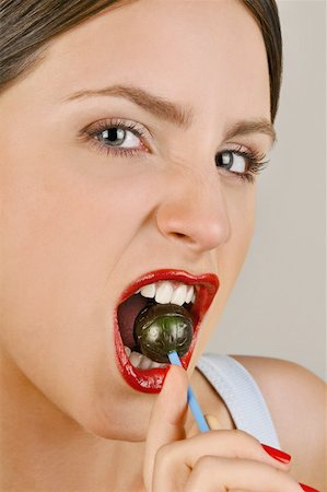 simsearch:644-02153088,k - Female young adult biting a lollipop Stock Photo - Premium Royalty-Free, Code: 644-02153084