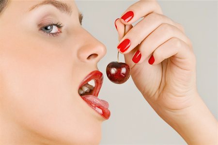 simsearch:644-02153088,k - Female young adult eating a cherry Stock Photo - Premium Royalty-Free, Code: 644-02153086