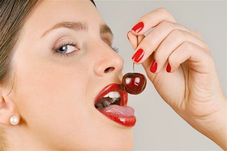 simsearch:644-02153088,k - Female young adult eating a cherry Stock Photo - Premium Royalty-Free, Code: 644-02153088