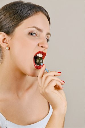 simsearch:644-02153088,k - Female young adult biting a lollipop Stock Photo - Premium Royalty-Free, Code: 644-02153082