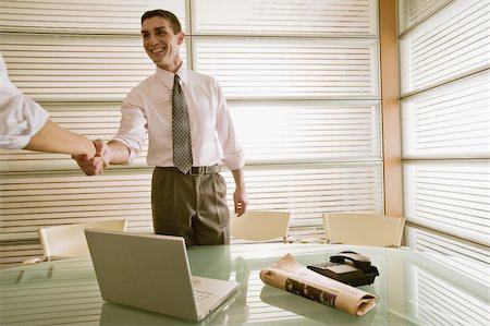 Businessman in office greeting businesswoman Stock Photo - Premium Royalty-Free, Code: 644-02923336