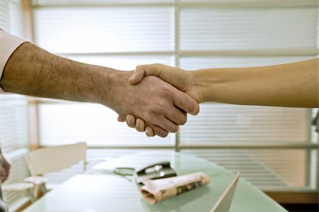 Businessman and businesswoman shaking hands Stock Photo - Premium Royalty-Free, Code: 644-02923338