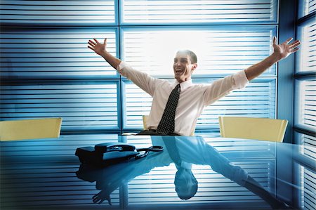 Businessman rejoicing at desk Stock Photo - Premium Royalty-Free, Code: 644-02923332