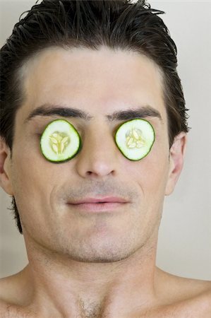 french men - Young man with cucumber slices on his eyes Stock Photo - Premium Royalty-Free, Code: 644-02923398