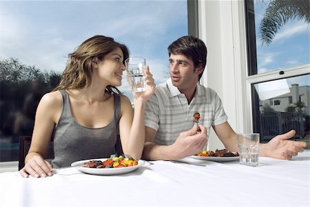 Young couple eating at table Stock Photo - Premium Royalty-Free, Code: 644-02923390