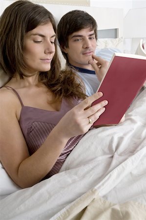 Young couple in bed relaxing Stock Photo - Premium Royalty-Free, Code: 644-02923460