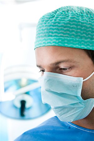 Close up of surgeon in operating room Stock Photo - Premium Royalty-Free, Code: 644-03659452