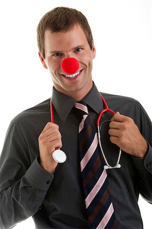 Doctor with stethoscope and clown's nose Stock Photo - Premium Royalty-Free, Code: 644-03659577